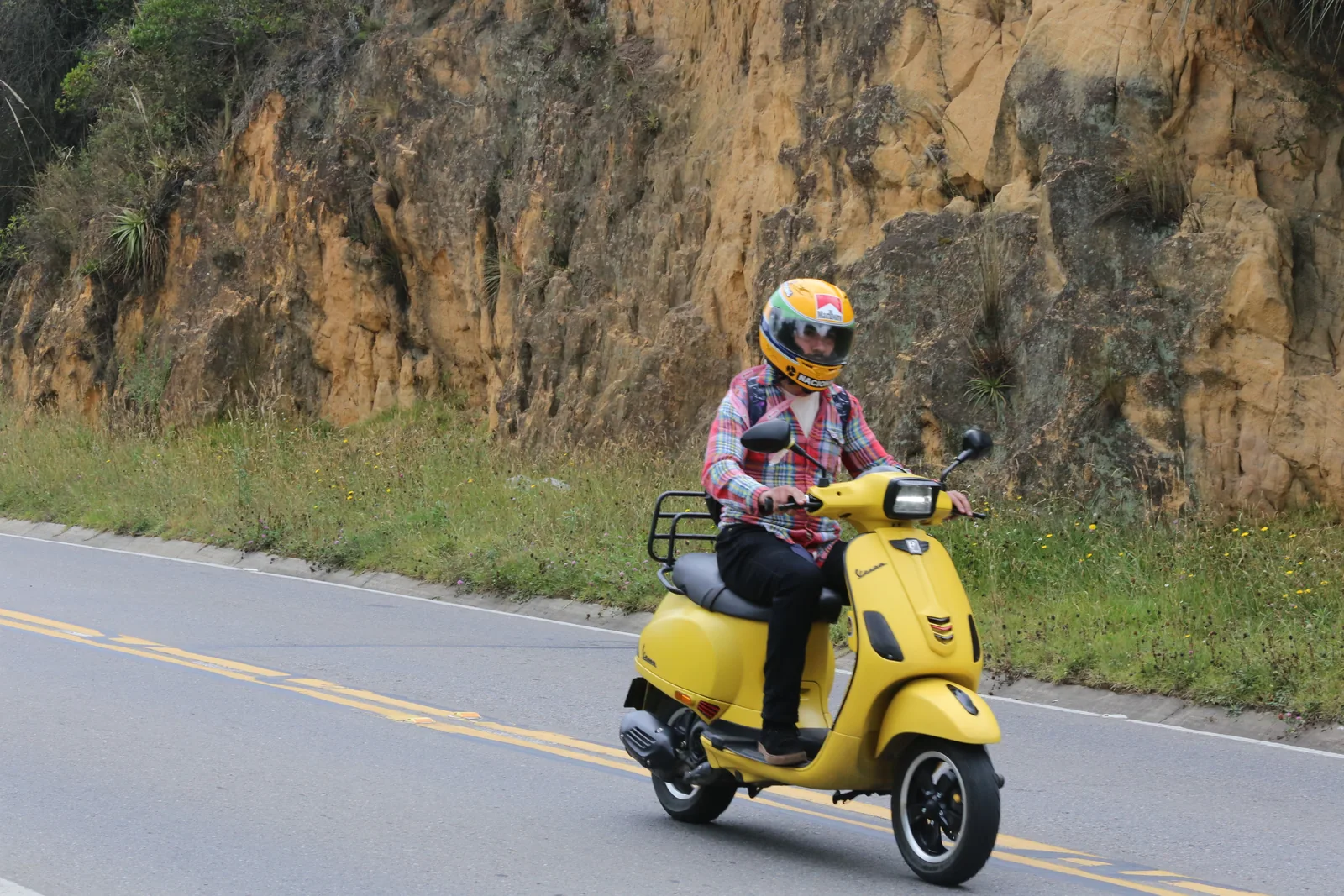 Una participante en una scooter amarilla recorre la carretera durante La Ruta Rosa 2026.